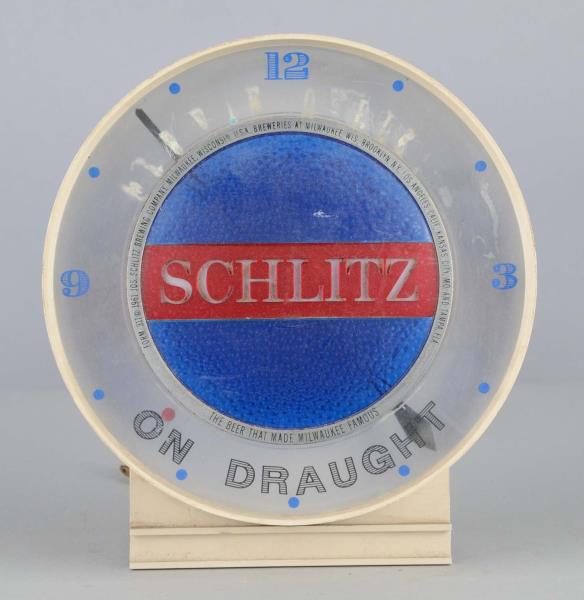 Appraisal: Schlitz Beer Lighted Advertising Clock This beige plastic electric clock