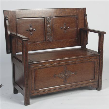 Appraisal: A th century oak monk's bench the panelled back over