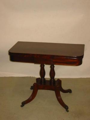 Appraisal: A MAHOGANY FOLDING CARD TABLE of rounded oblong form swivel