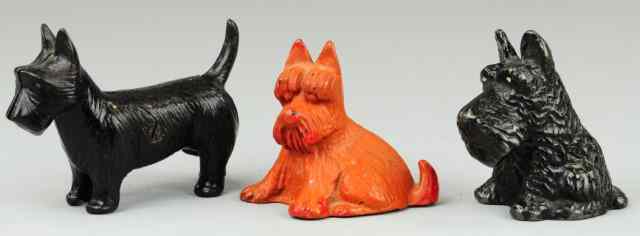 Appraisal: THREE SCOTTIE DOG STILL BANKS Cast iron grouping includes black