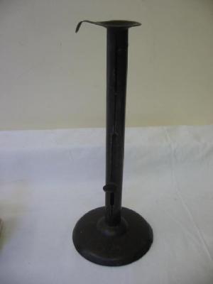 Appraisal: A WROUGHT IRON CANDLESTICKS with dished nozzle the cylindrical stem