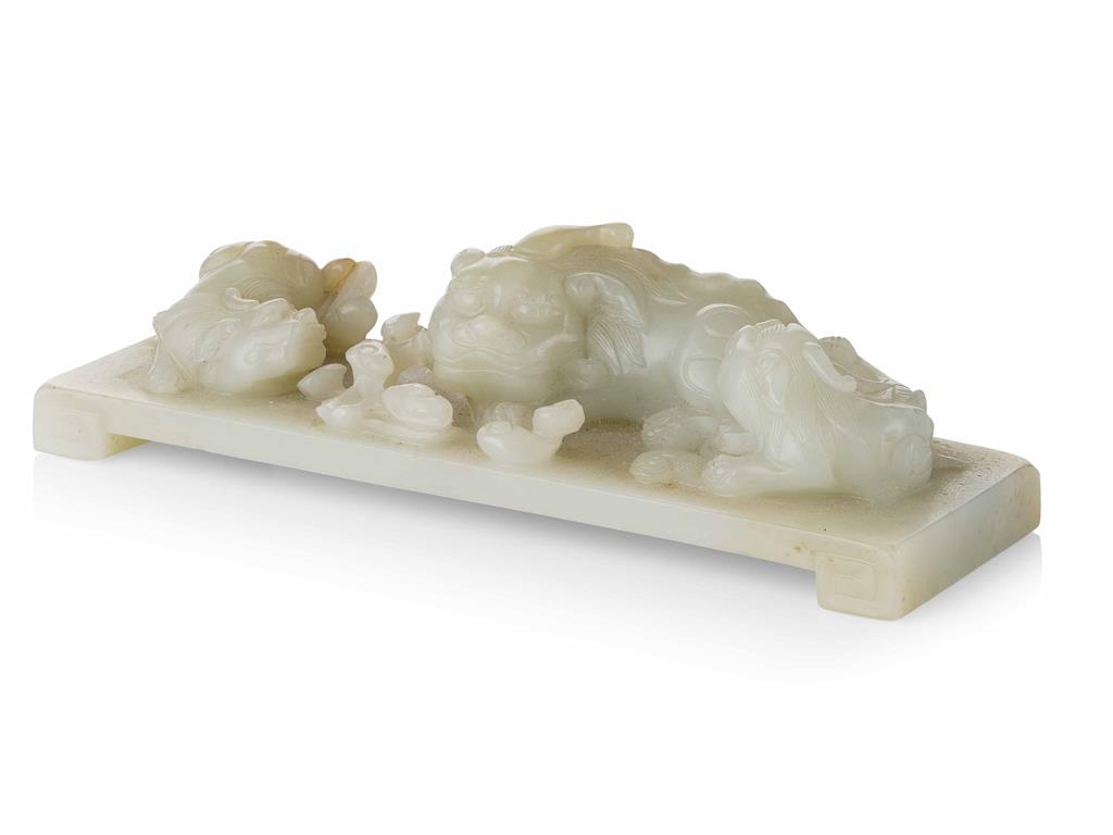 Appraisal: CELADON JADE CARVING OF A BUDDHIST LION AND TWO CUBS