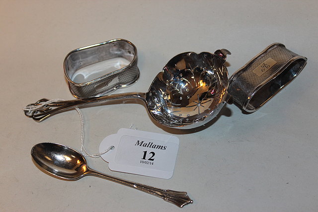 Appraisal: A SILVER TEA STRAINER with pierced handle and lobed bowl