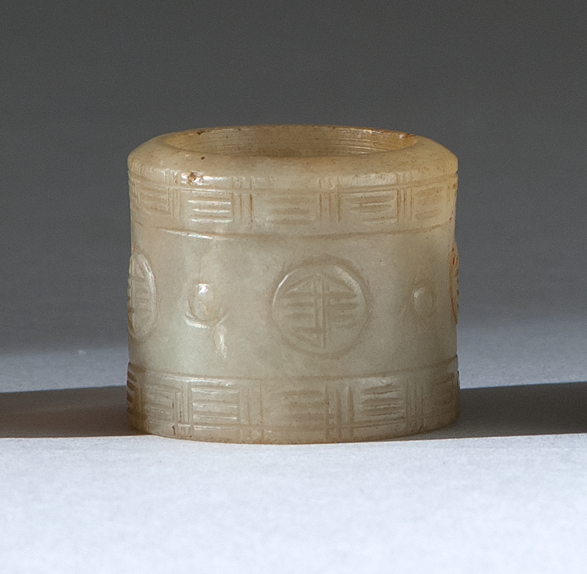 Appraisal: CELADON JADE THUMB RING Late th CenturyWith shou medallions and