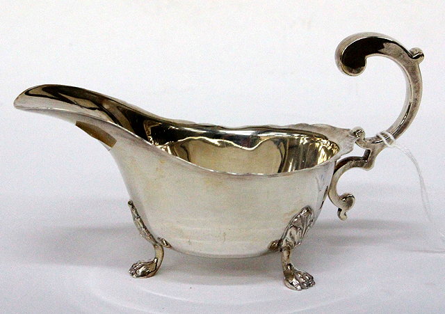 Appraisal: A SILVER SAUCE BOAT with C scroll handle and three