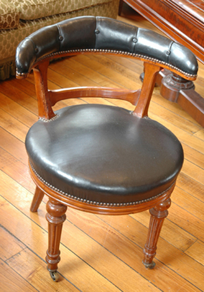 Appraisal: A PAIR OF VICTORIAN MAHOGANY LIBRARY CHAIRS The semi-circular buttoned