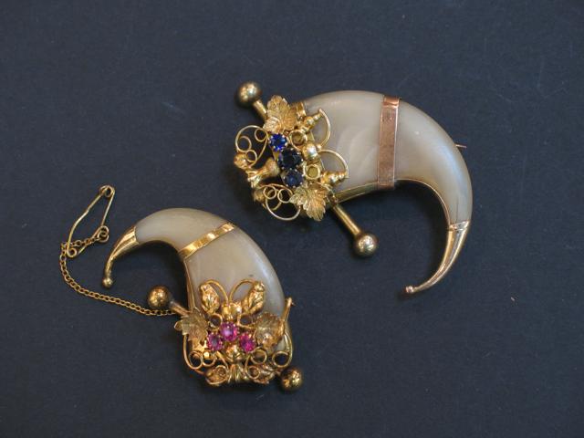 Appraisal: TWO VICTORIAN TIGER CLAW BROOCHES each mounted in yellow gold