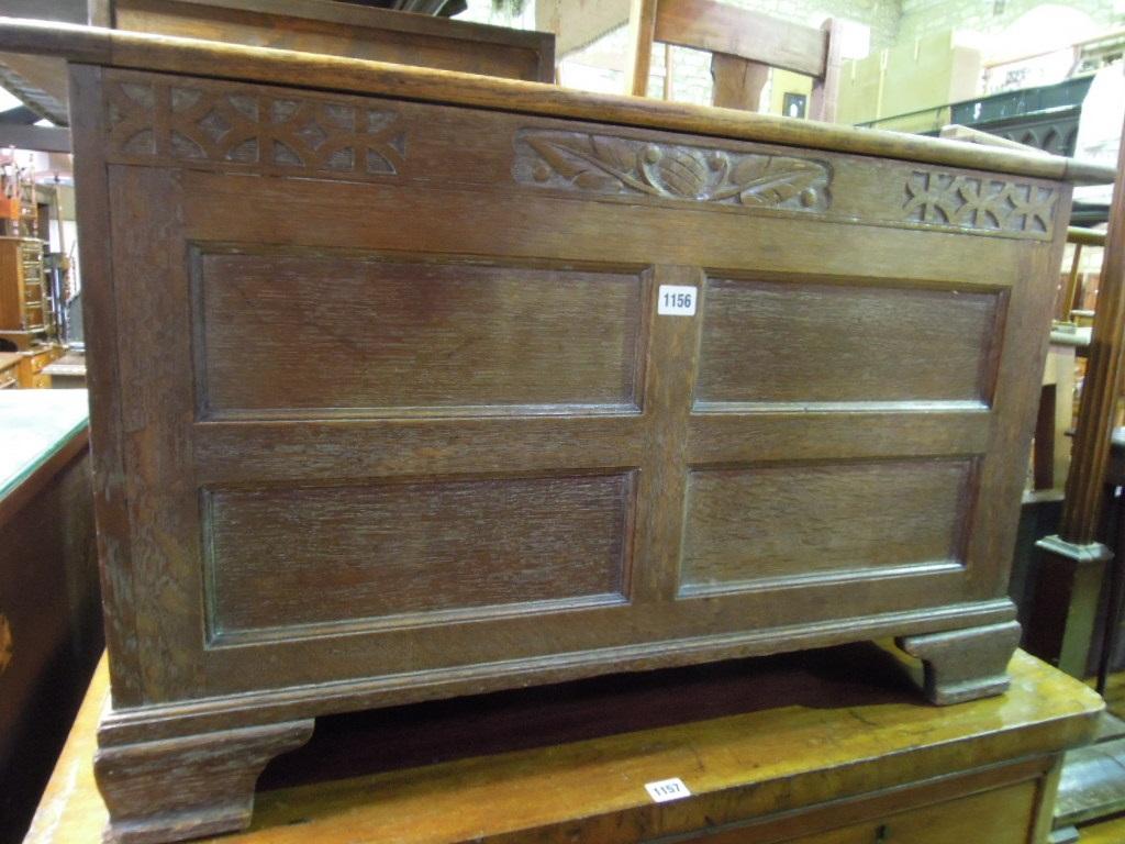 Appraisal: A small limed oak coffer with panelled frame and carved