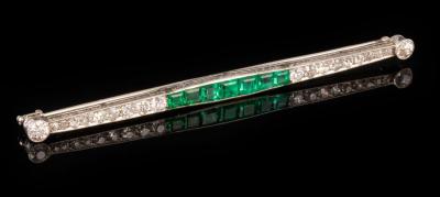 Appraisal: An emerald and diamond bar brooch set with a central