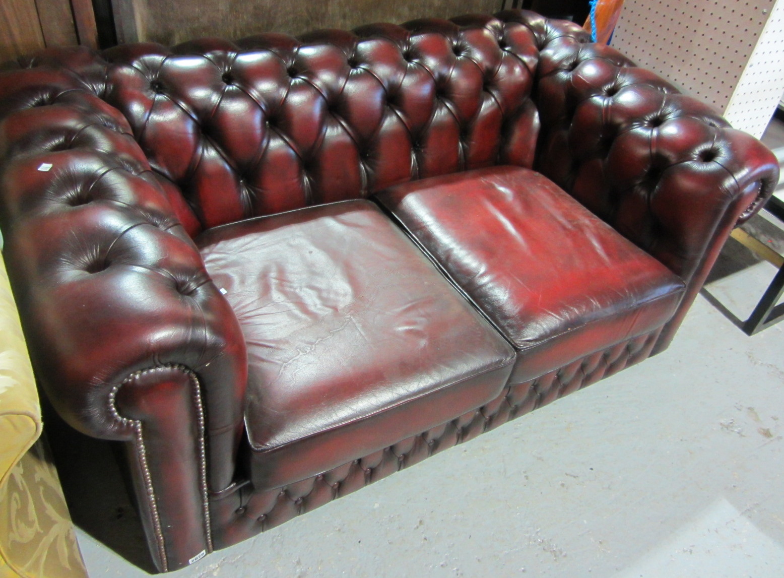 Appraisal: A th century red leather Chesterfield style three seat sofa