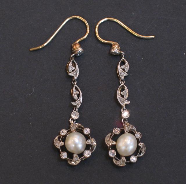 Appraisal: A PAIR OF EDWARDIAN DROP EARRINGS of scroll design millegrain-set