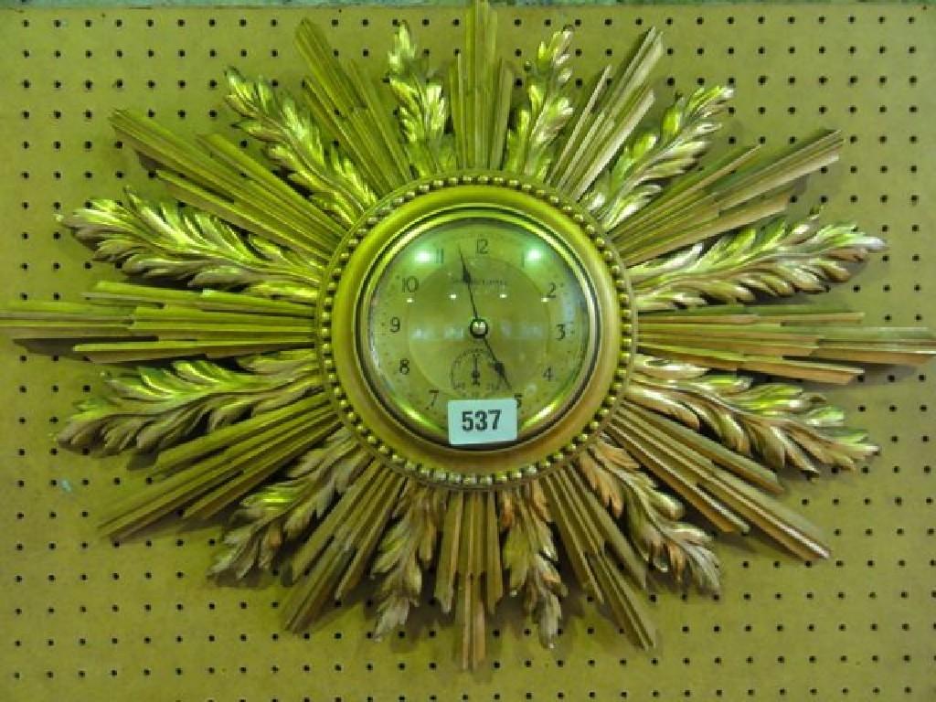 Appraisal: A Sunburst dial clock with gilded frame and Garrard electric