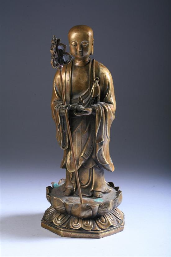 Appraisal: CHINESE BRONZE FIGURE OF MONK th century Standing on lotus