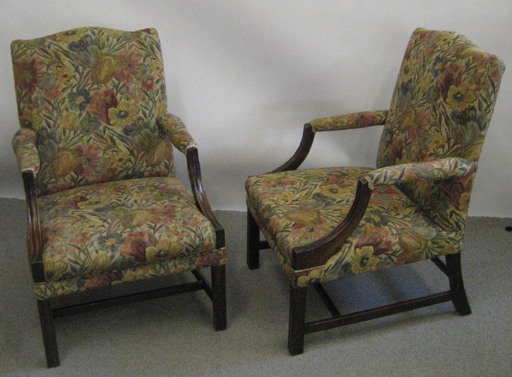 Appraisal: A PAIR OF GEORGE III STYLE MAHOGANY LIBRARY ARMCHAIRS upholstered