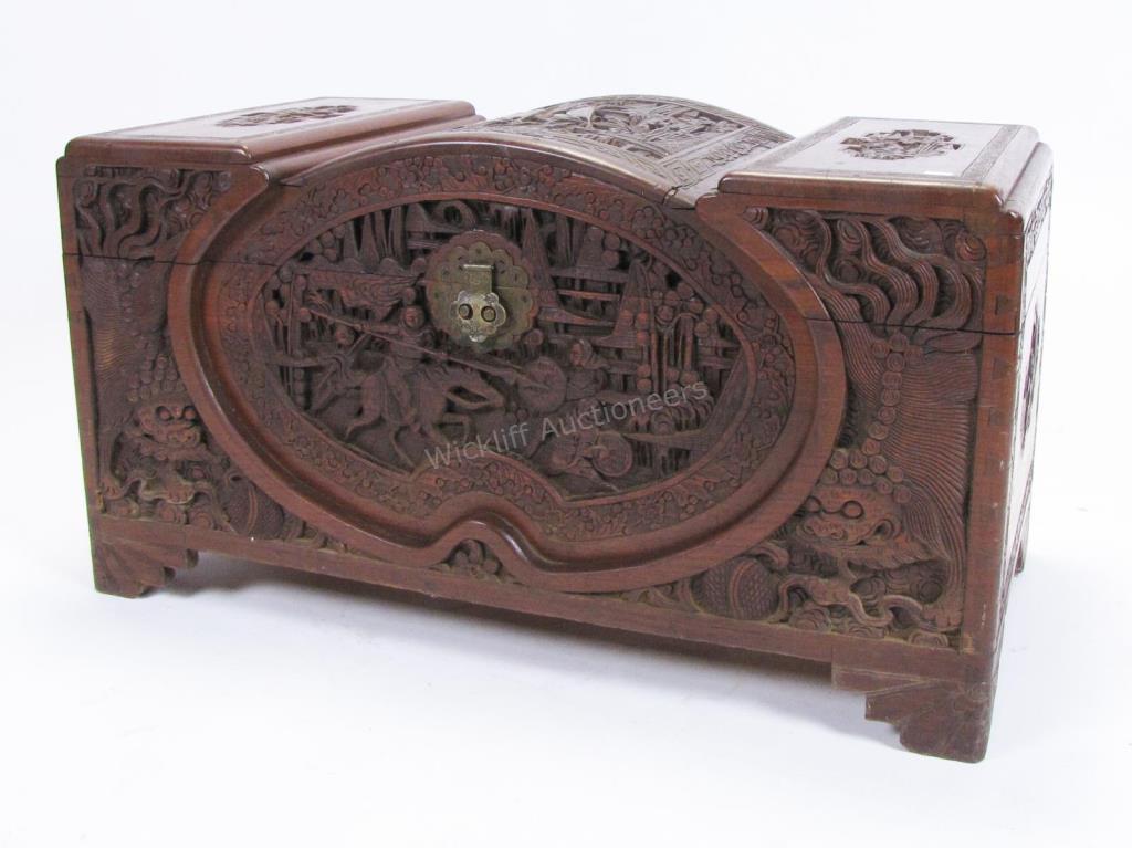 Appraisal: A vintage relief-carved Oriental trunk depicting boats in harbor and