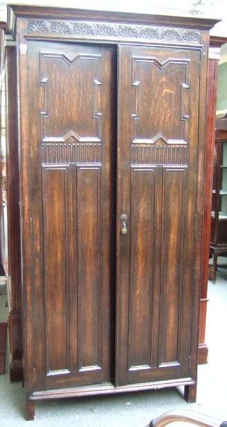 Appraisal: A th century style oak hall cupboard with a pair