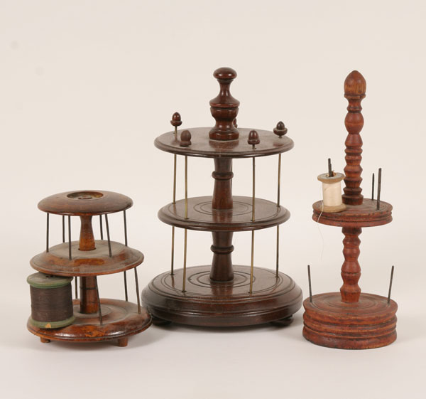 Appraisal: Three th century wooden sewing spool holders various sizes and