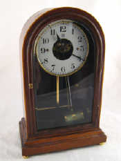 Appraisal: An early Boulle volt battery electric clock the domed mahogany