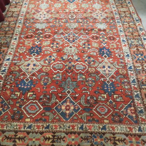 Appraisal: Persian Handmade Rug geometrics stylized floral on salmon field '