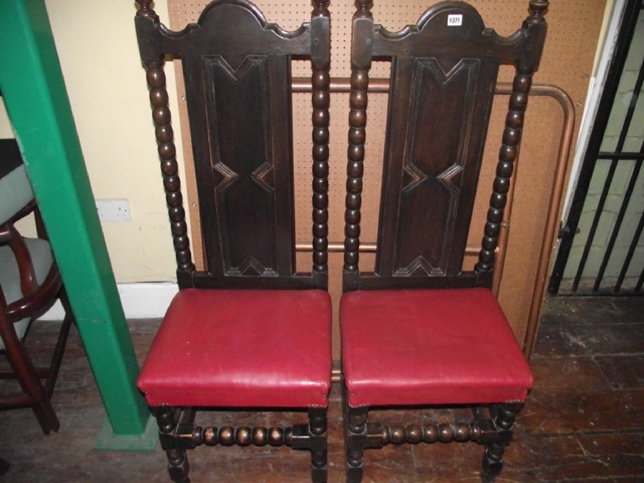 Appraisal: A pair of Edwardian oak side chairs with panelled backs