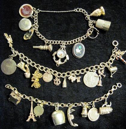 Appraisal: Group of three yellow gold charm bracelets Featuring various gold