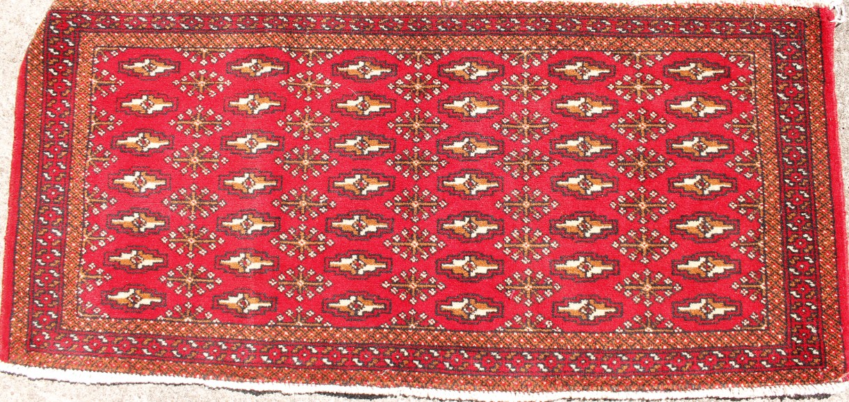 Appraisal: A Persian Turkoman rug with a design of red medallions