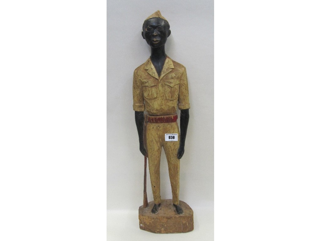 Appraisal: Carved wooden figure of an African man in military dress