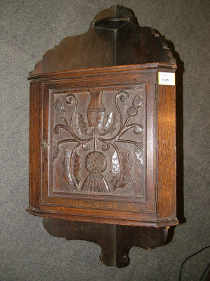 Appraisal: A carved oak corner cabinet together with a mahogany trolley