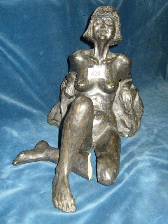 Appraisal: A ceramic figure of a seated female nude character with