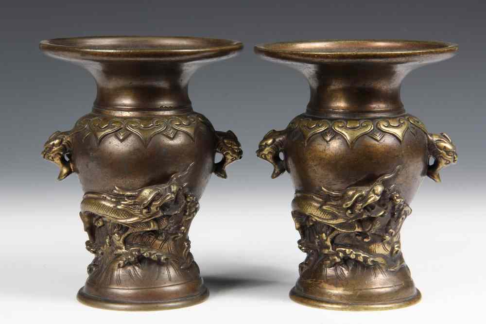 Appraisal: PAIR OF BRONZE JAPANESE VASES Meiji period decorated with dragons