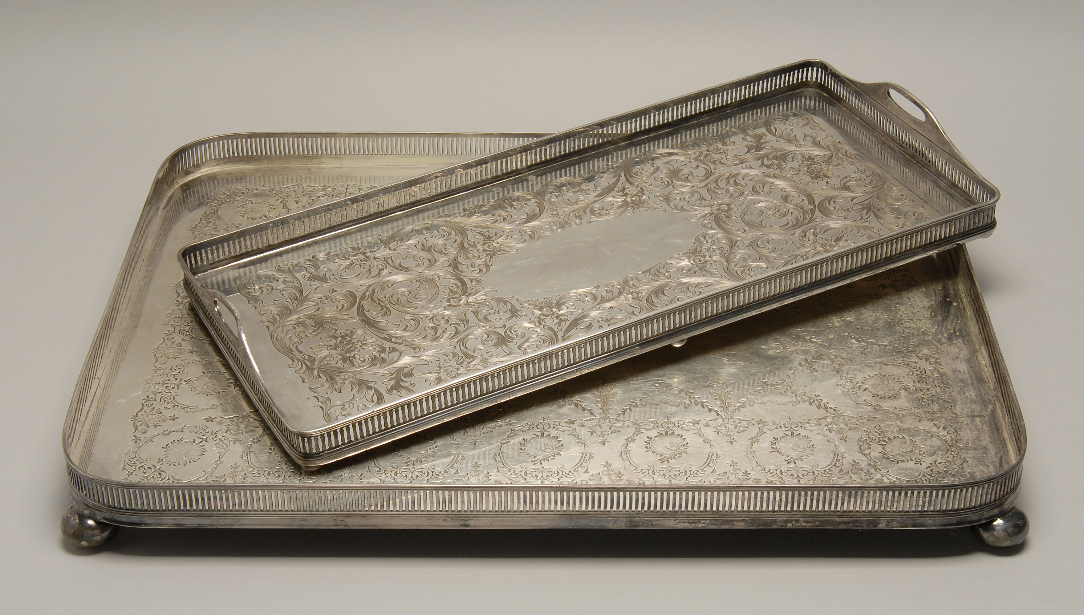 Appraisal: TWO SILVER PLATED GALLERIED SERVING TRAYS Largest one is by