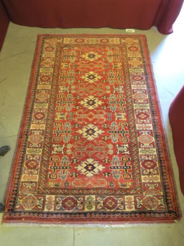 Appraisal: Kazak Persian Handmade Rug interesting designs overall red field '