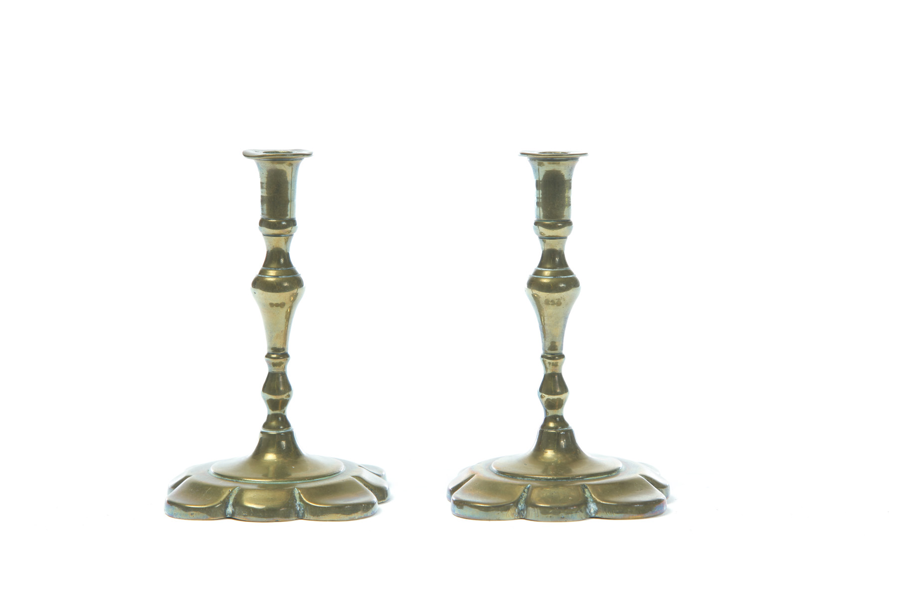 Appraisal: PAIR OF ENGLISH BRASS TAPER STICKS Eighteenth century Petal bases