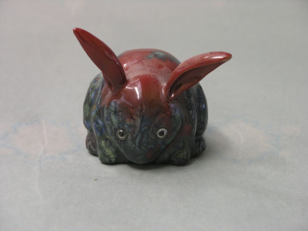 Appraisal: A Bernard Moore flambe rabbit model streaked glaze effects against