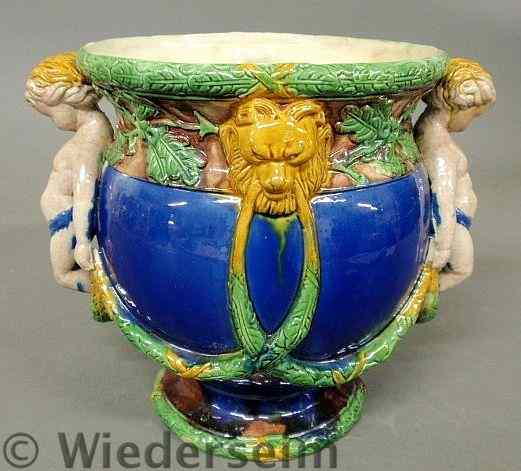 Appraisal: Italian majolica cachepot with lion masks and figures holding swag