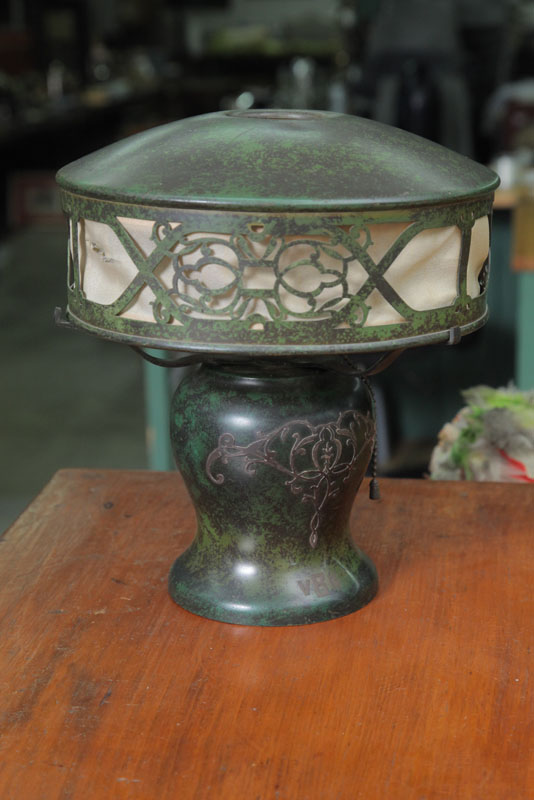 Appraisal: SMALL METAL TABLE LAMP Green patina with silver overlay on