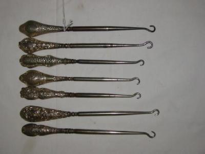 Appraisal: SEVEN VARIOUS BUTTON HOOKS with steel ends and embossed hafts