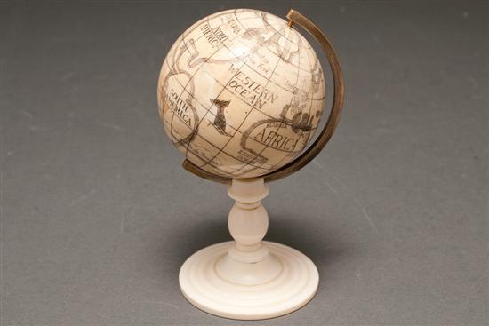 Appraisal: Continental carved scrimshaw decorated ivory miniature globe on turned ivory