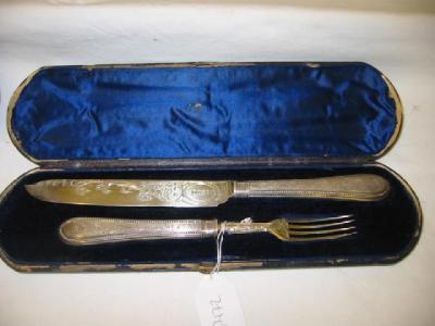 Appraisal: A VICTORIAN SERVING KNIFE AND FORK the blade chased with