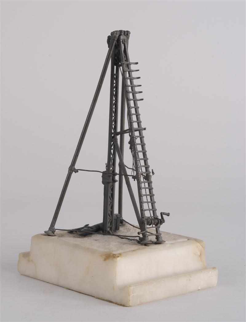 Appraisal: BRONZE MODEL OF A DRILL RIG The tripod structure with