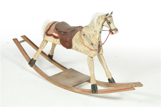 Appraisal: ROCKING HORSE American late th century mixed woods Leather saddle