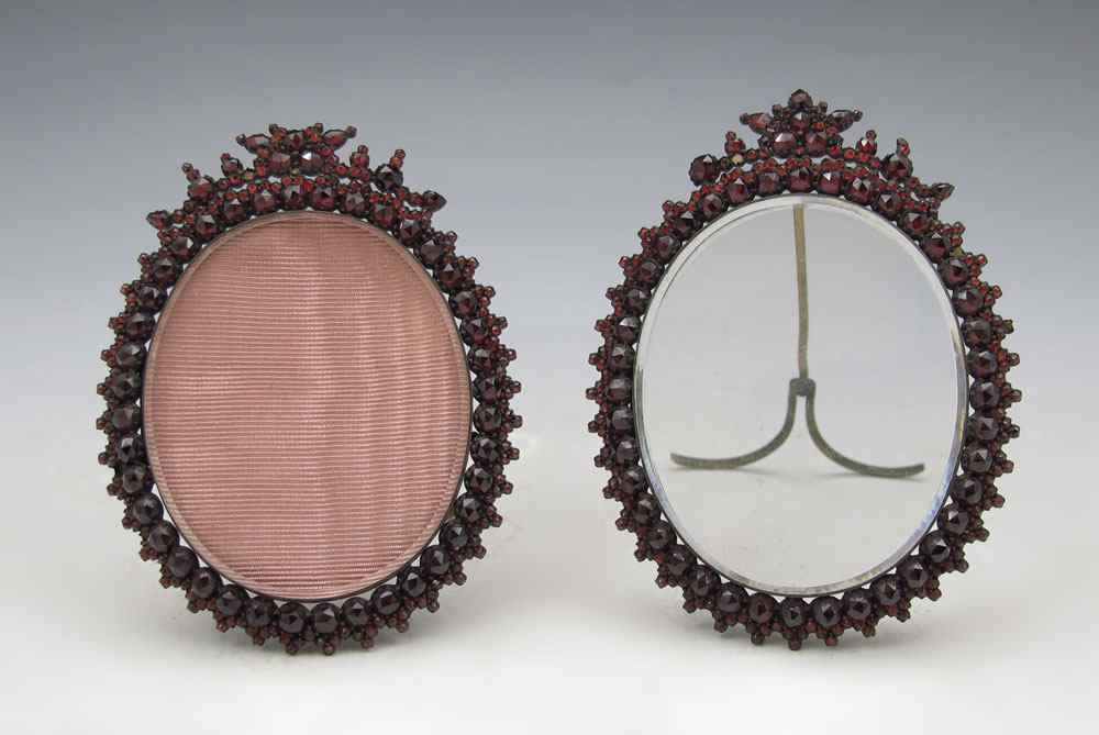 Appraisal: PAIR VICTORIAN GARNET FRAMES Mid 's Oval glass framed in