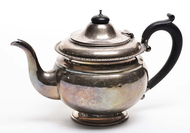 Appraisal: A TH CENTURY SILVER BACHELORS TEAPOT with ebony handle marks