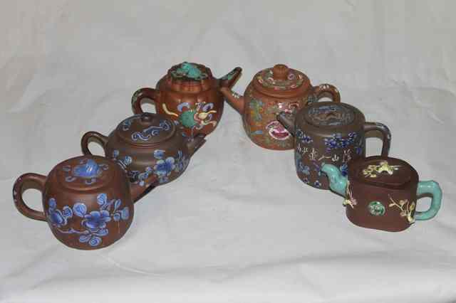 Appraisal: A COLLECTION OF EIGHT YIXING TEAPOTS each with polychrome enamel