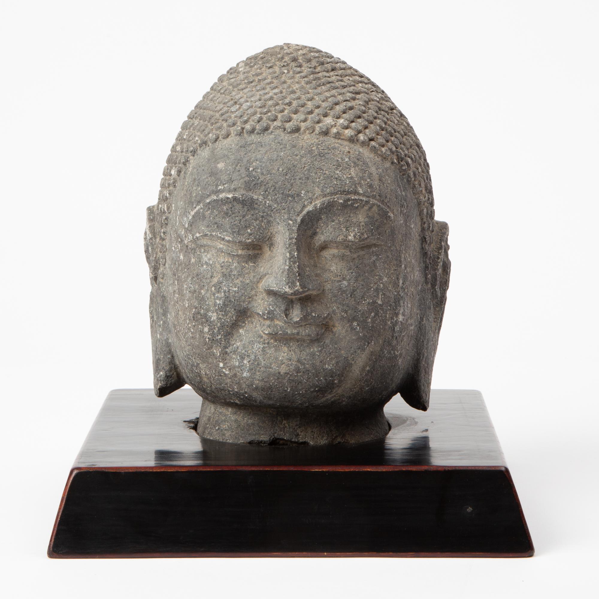 Appraisal: FINELY CARVED STONE BUDDHA HEAD A finely carved stone depiction