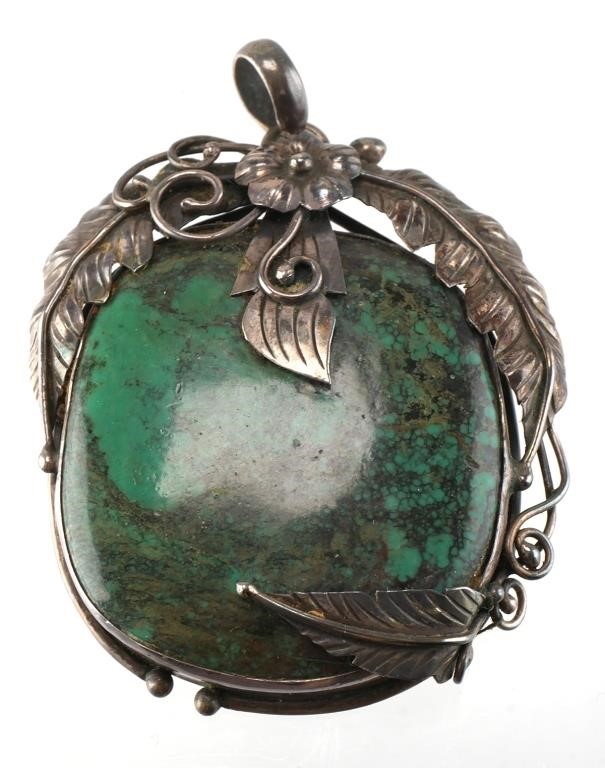 Appraisal: Native American style sterling silver pendant featuring a large turquoise