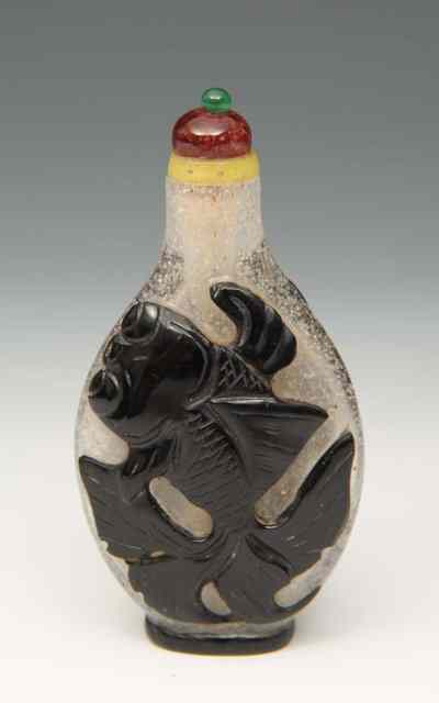 Appraisal: A CARVED BEIJING PEKING GLASS SNUFF BOTTLE and stopper decorated