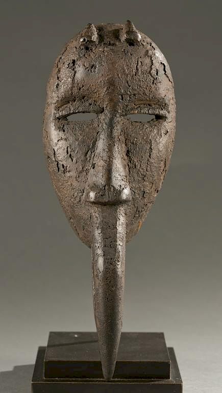 Appraisal: Dan mask with avian beak th c An encrusted mask