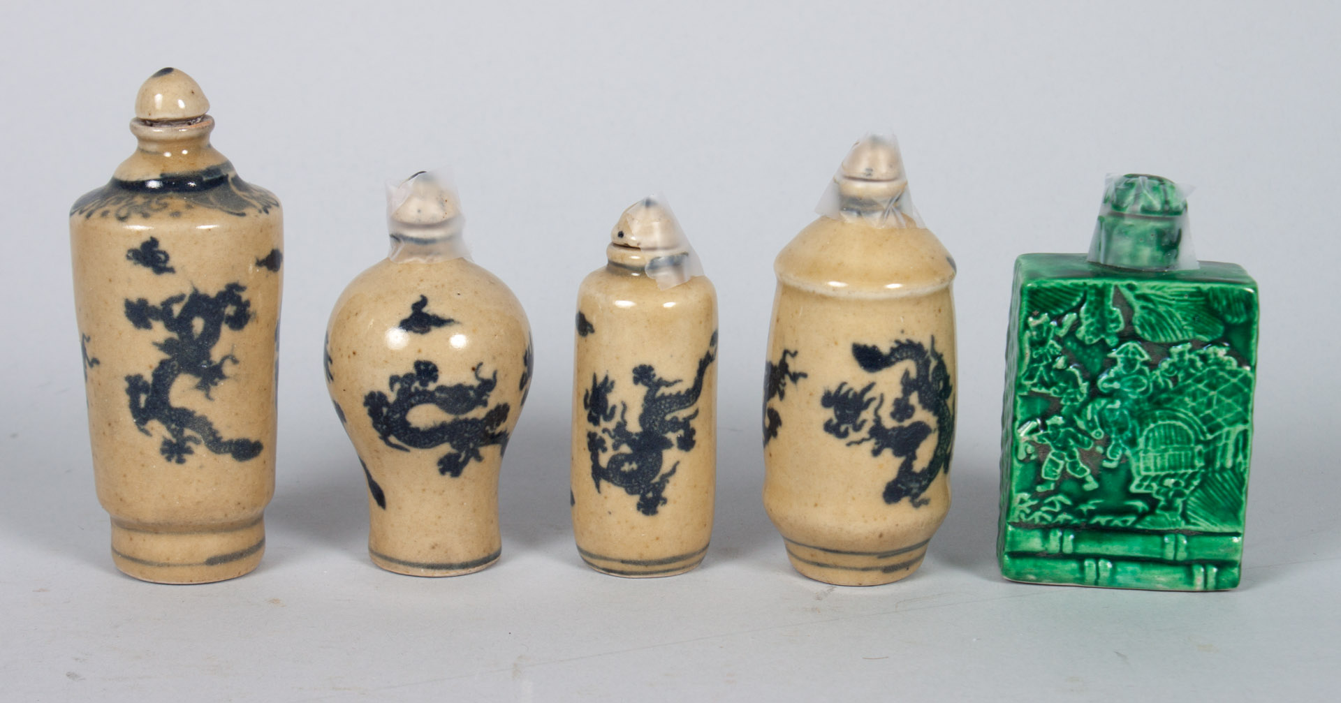 Appraisal: Five Chinese porcelain snuff bottles including square form with green