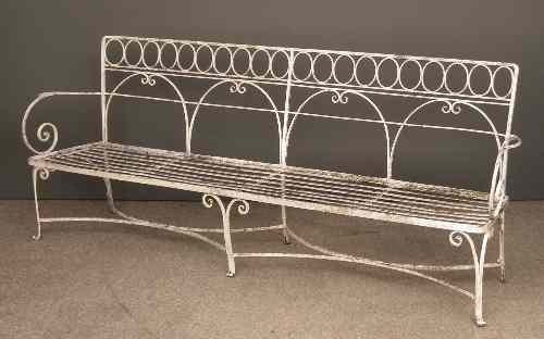 Appraisal: A white painted wrought iron garden bench of th Century